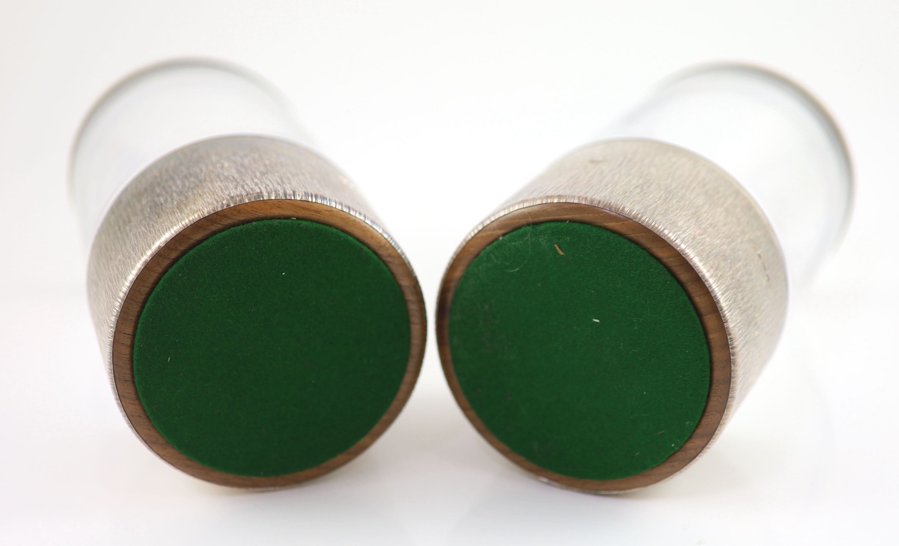 A pair of textured silver bottle coasters by Adrian Gerald Benney, with removeable silver mounted plastic liners